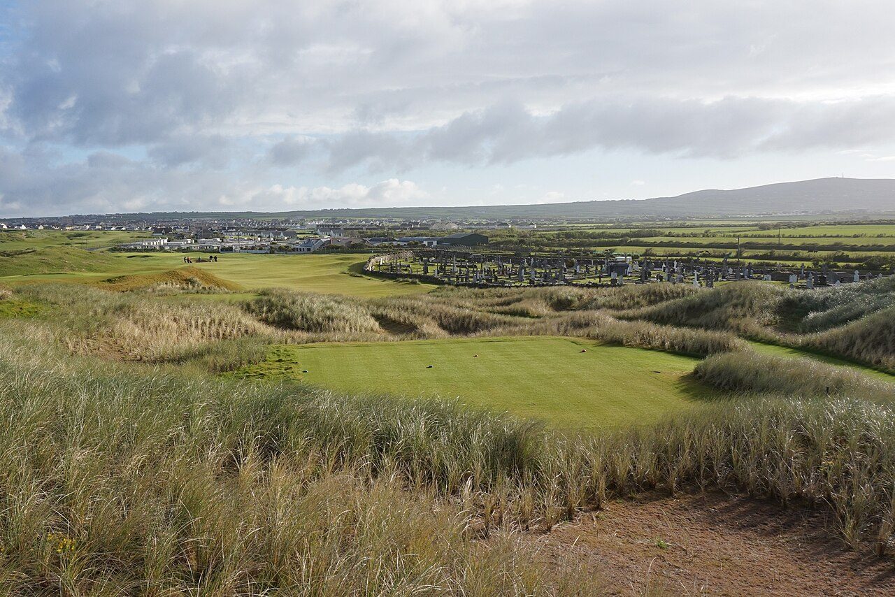 The first hole at Ballybunion Old Course, with dunes and the town beyond
