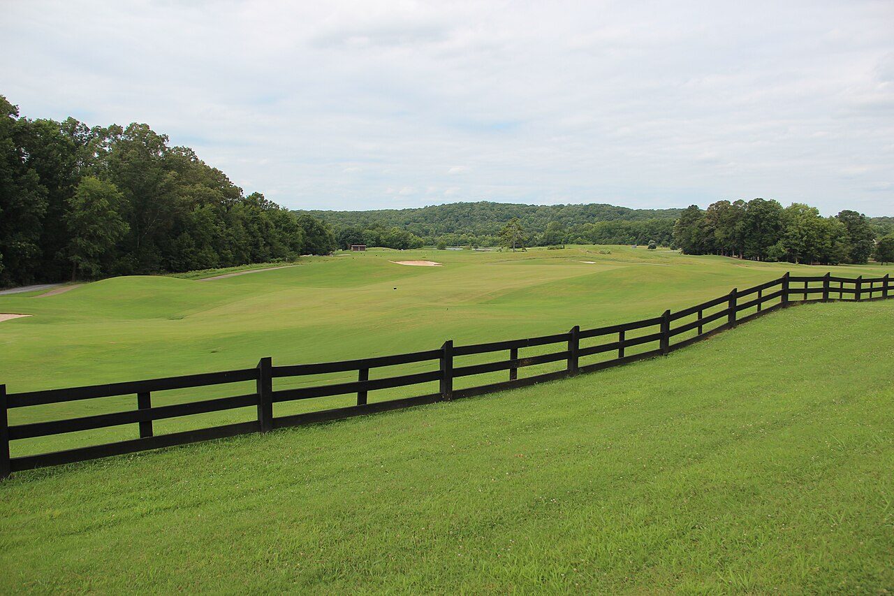 A fairway lined by a black wooden fence at Barnsley Resort in north Georgia