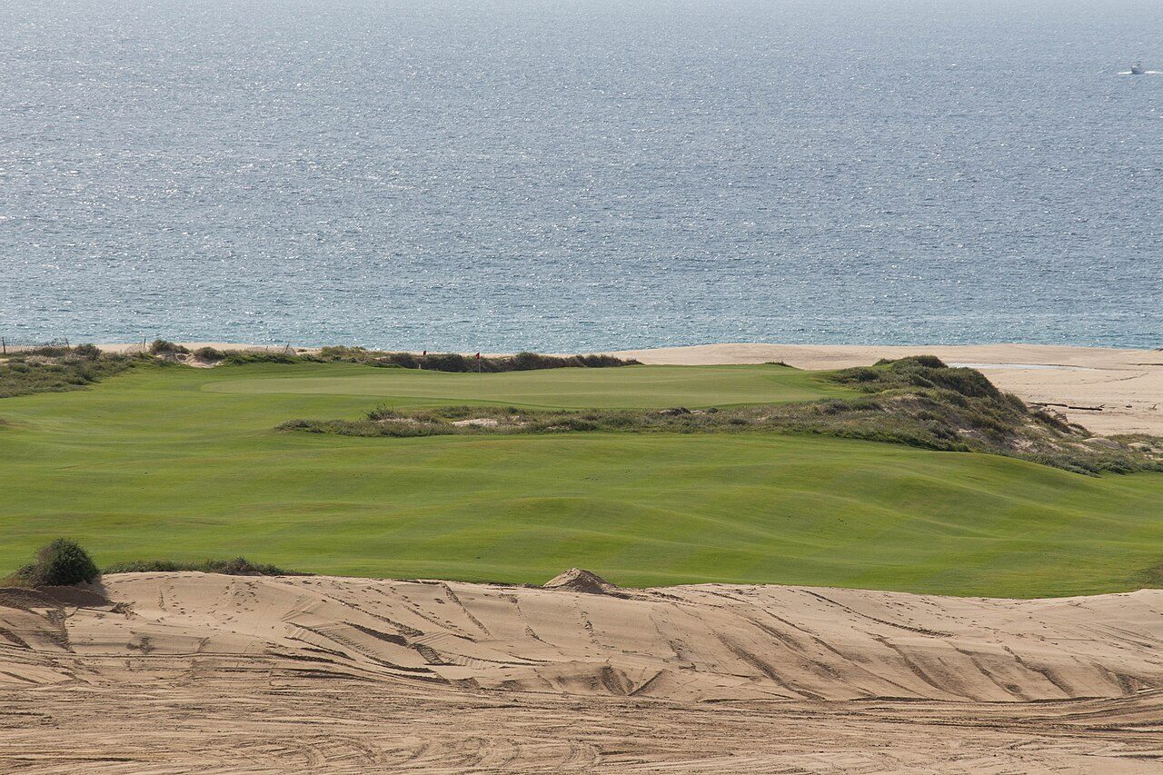 Dune-framed fairway on the Dunes course at Diamante in Cabo San Lucas, with the Pacific behind