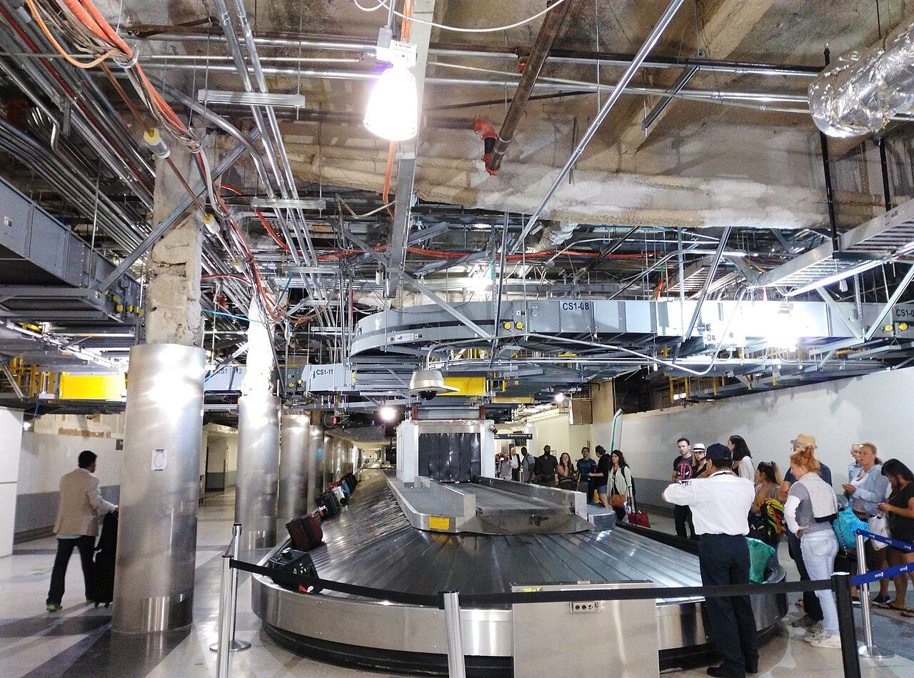 Passengers waiting at a baggage carousel at Los Angeles International Airport