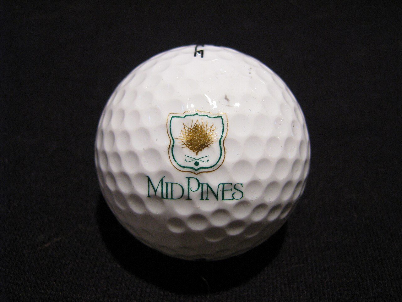 A Mid Pines golf ball with the club's pine-tree logo