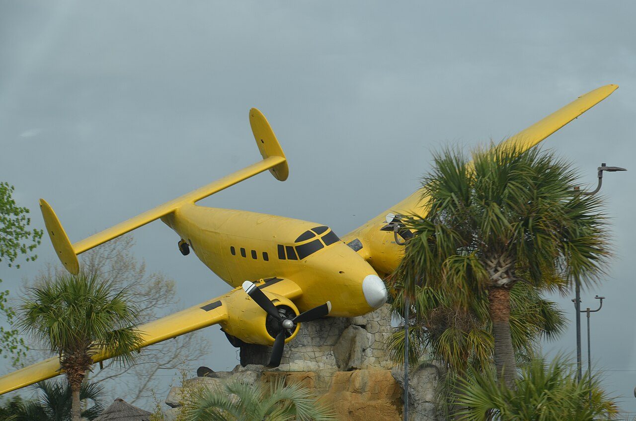 A miniature golf course in North Myrtle Beach with a yellow vintage airplane perched above the holes
