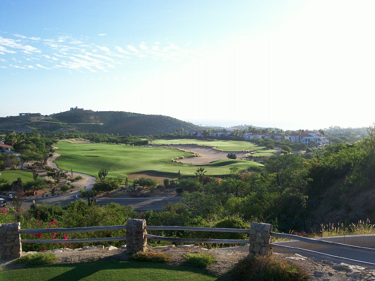 Fairways winding through the desert hills at Palmilla in Los Cabos, with the resort beyond
