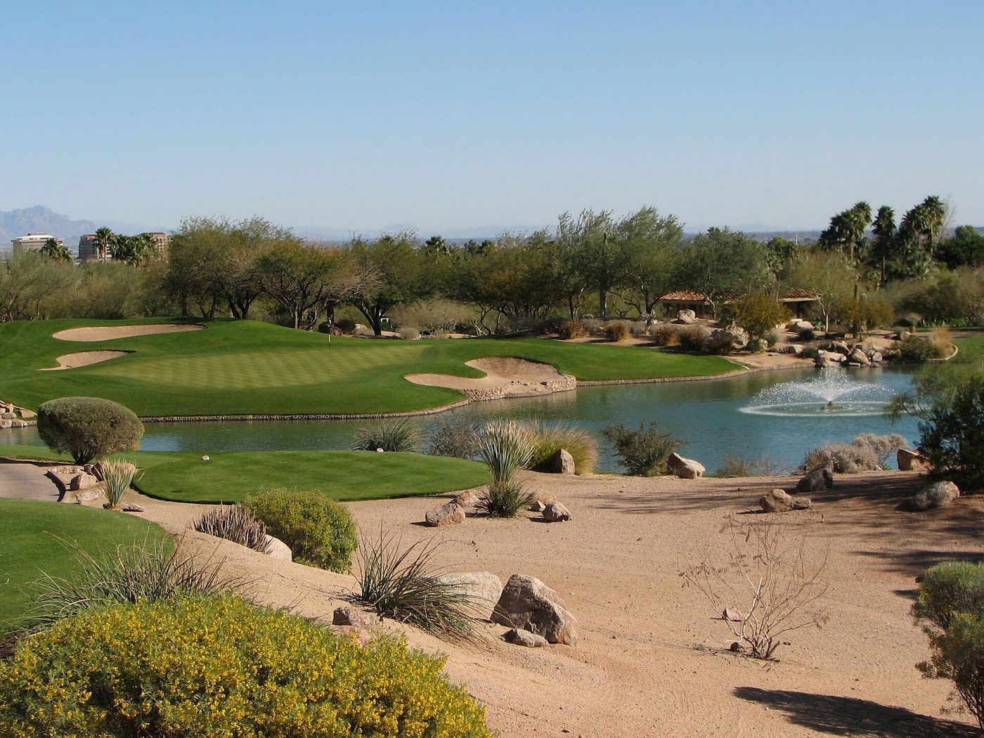 Desert-landscaped par 3 with a pond and fountain on the Canyon course at The Phoenician, Scottsdale