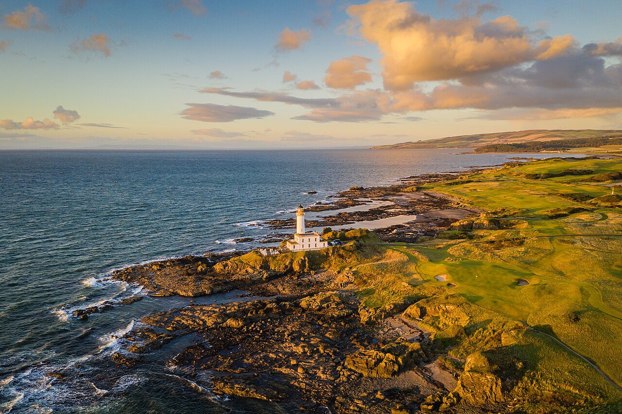 The lighthouse at Turnberry at sunset, with the Ailsa course along the rocky shore