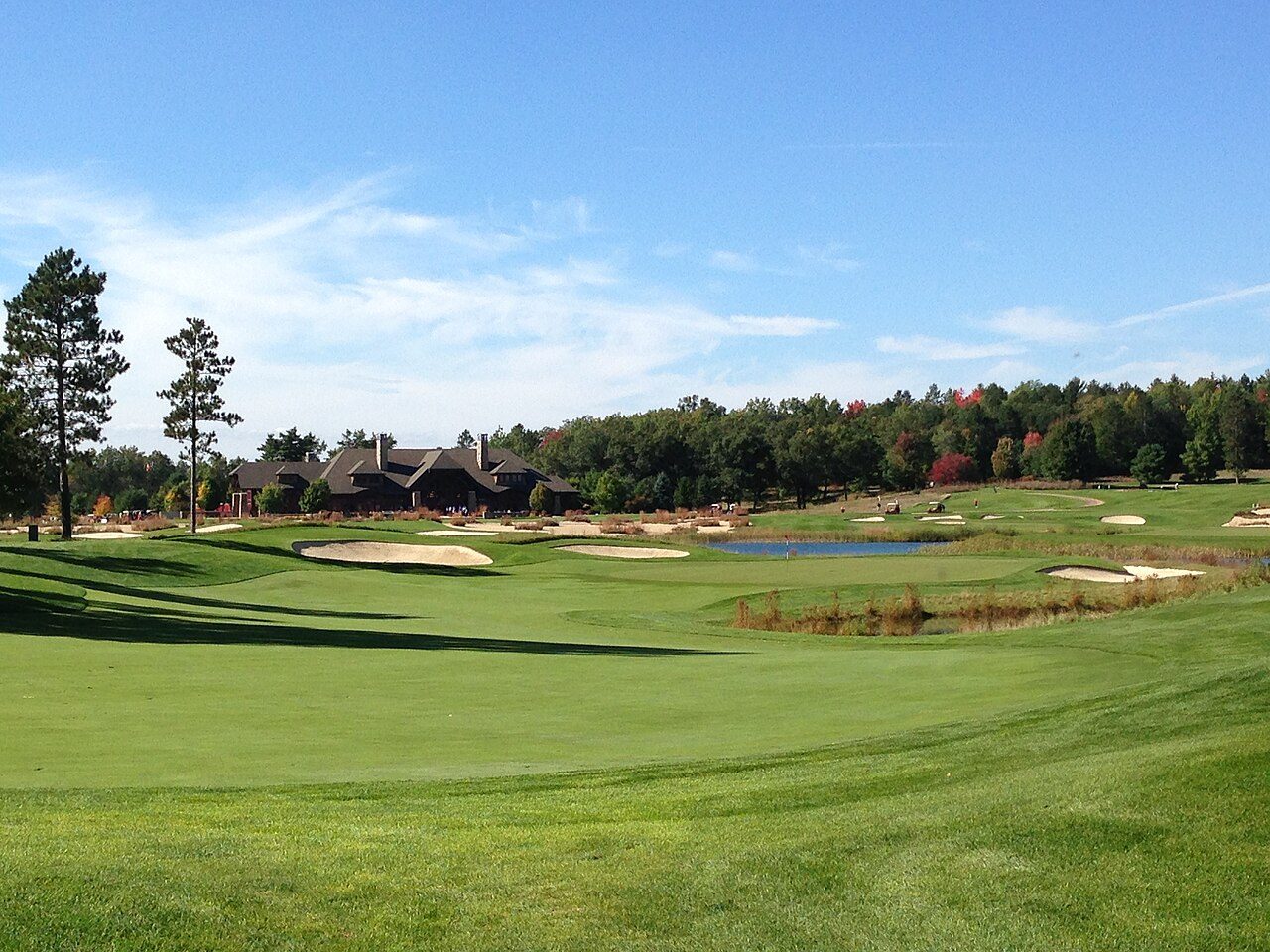 A green and bunkers below the clubhouse on the 8th hole at Forest Dunes in northern Michigan