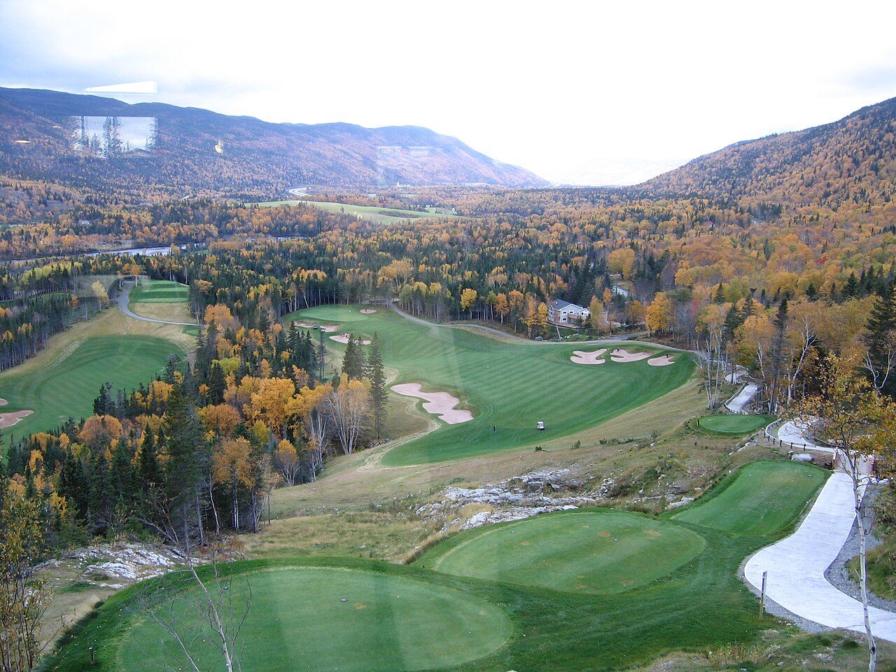 A golf course among hills in autumn color at Humber Valley in western Newfoundland