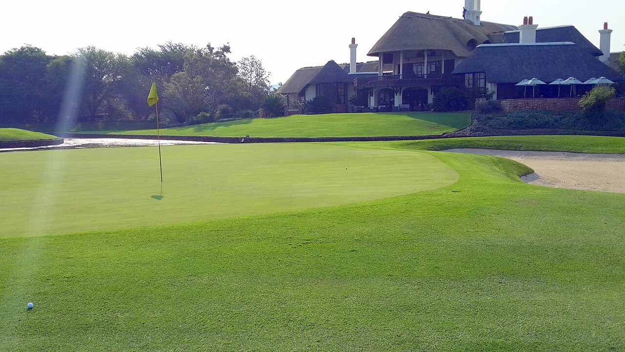 The 9th green below the thatched clubhouse at Leopard Creek, beside Kruger National Park