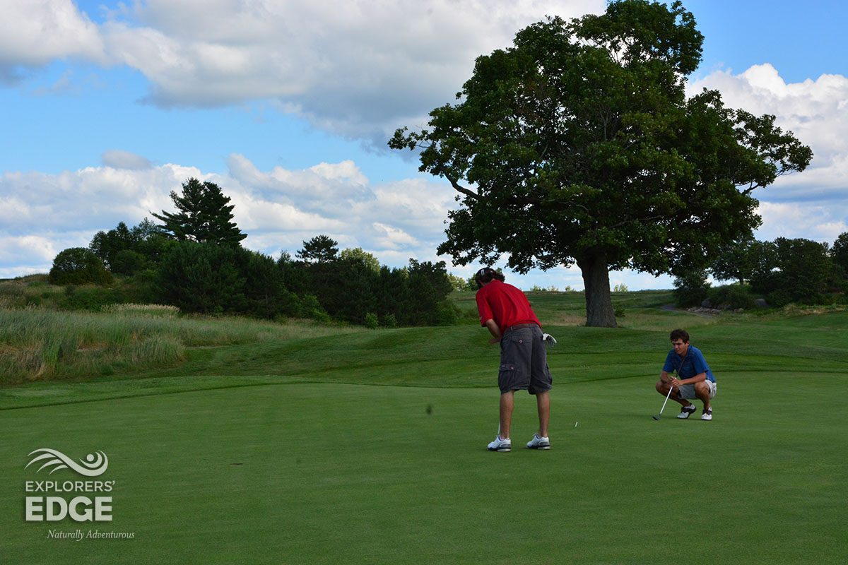 Golfers putting on a green in Ontario's Explorers' Edge region, which includes Muskoka