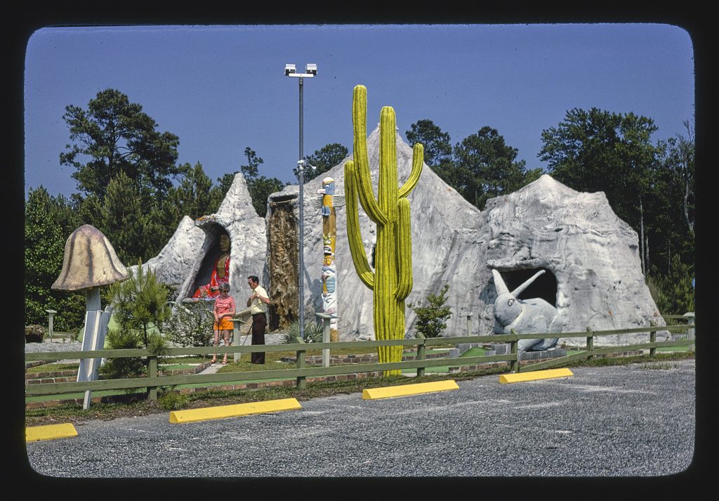 A vintage photograph of Wacky Golf in Myrtle Beach, with a stone cave and a giant cactus